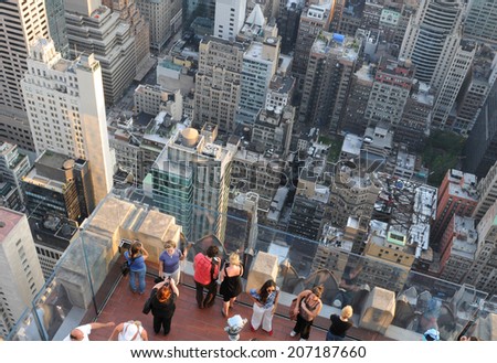 NEW YORK ,USA - JUNE 18: Tourists enjoy New York cityscape from Rockefeller center roof  on June 18 2011, New York USA.