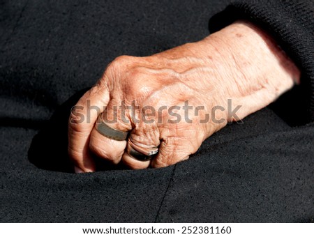 Senior woman  aged hand with fingers closed. Concept of aging process.