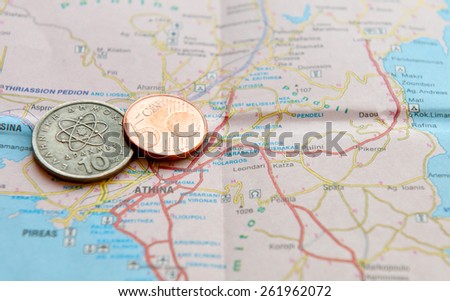 One Euro coin and greek drachma on a Greek Map. Concept of Greece and European community financial Crisis.