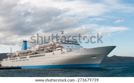 Passenger Luxury Cruise ship on tied on a pier at  Agios Nikolaos Harbor in the island of  Crete in Greece.