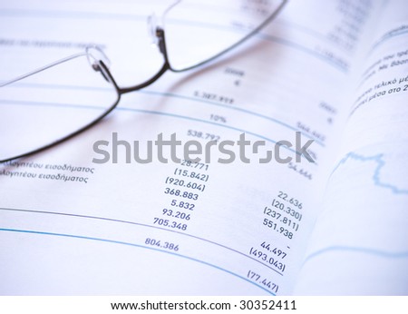 Financial statement and eye glasses.