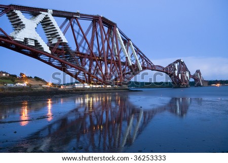 The world-famous Forth Rail Bridge at sunset. Repairing works are taking place on the bridge