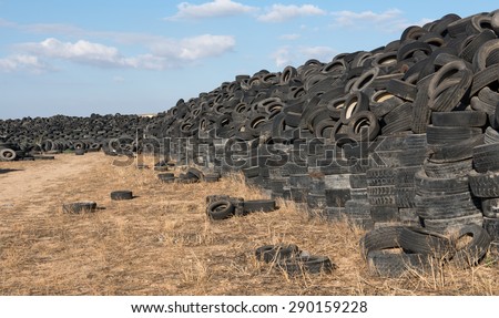 Old  used rubber tires  piled  in a recycling yard waiting to be  shredded and  re manufactured into usable  products