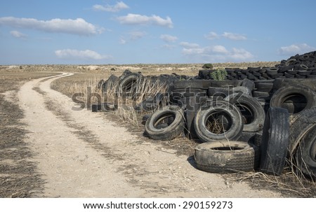 Old  used rubber tires  piled  in a recycling yard waiting to be  shredded and  re manufactured into usable  products