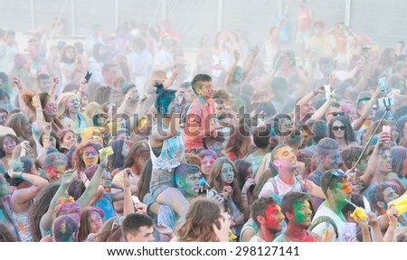 LARNACA, CYPRUS- JULY 18:: People with color aces and bodies dancing and enjoying the  Colour War festival held  on July 18 2015 in  Phoinikoudes Beach  in Larnaca , Cyprus