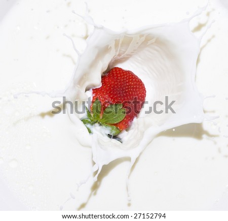 Splashing milk with fruit and berry