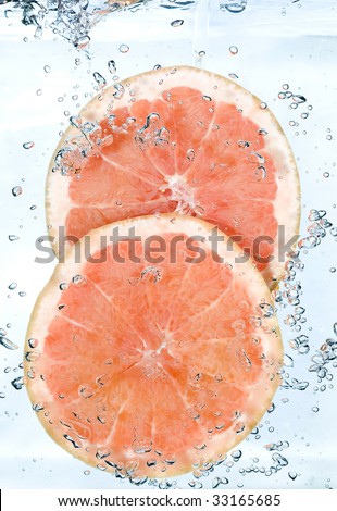 Red grapefruit in water. Creative fruit and bubbles water