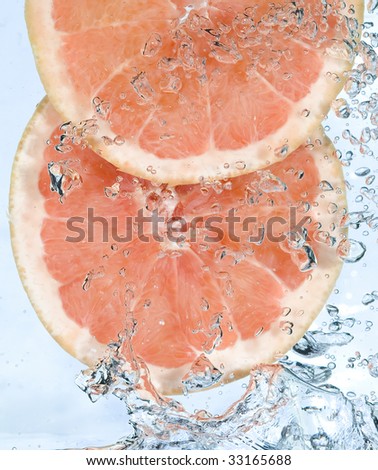 Red grapefruit in water. Creative fruit and bubbles water