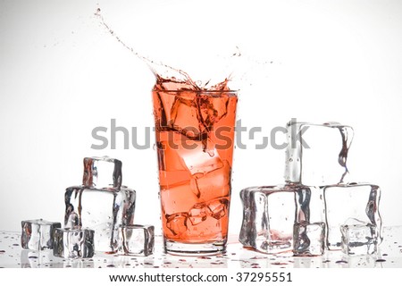 Red drink and ice. Splashing coktail