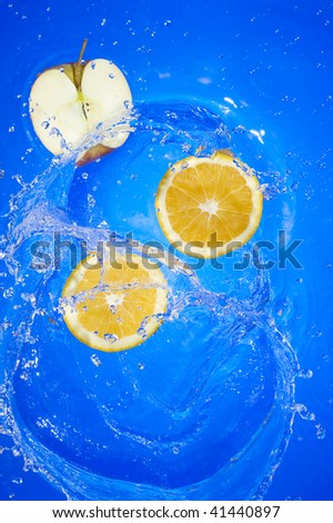 Oange with splashing water. Tropical citrus fruit