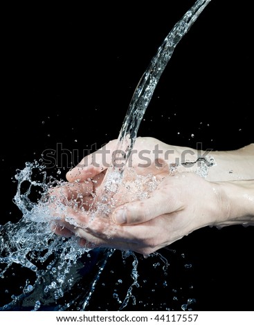 Hand and creative splashing water on black background