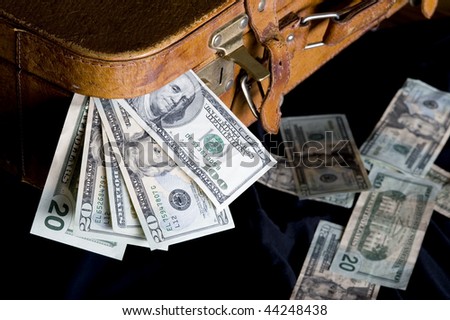 Cash dollar sticking out of overfilled case