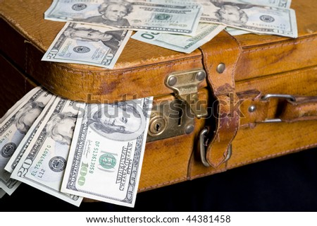 Cash ,dollar sticking out of overfilled case