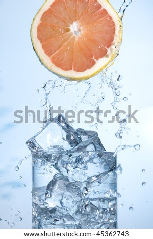 Fresh Grapefruit, with splashing water isolated on white background