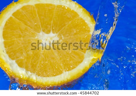 Orange with splashing water. Tropical citrus fruit