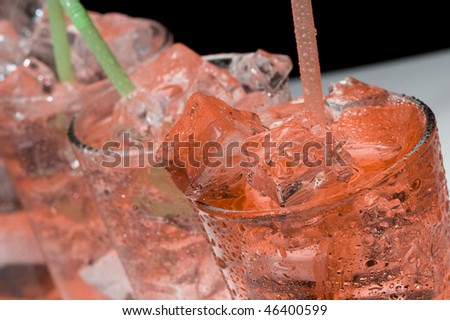 Red cocktail and ice. Cold de a alcoholic drink