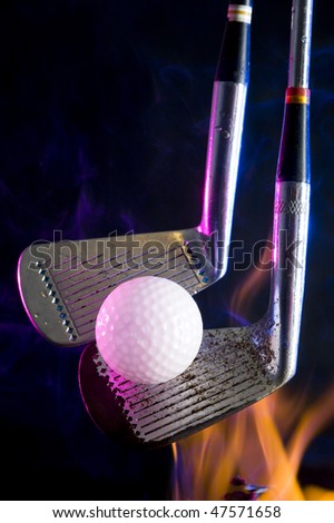 Golf clubs with  ball on black background