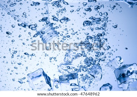 Mineral water with ice. Creative splashing blue water