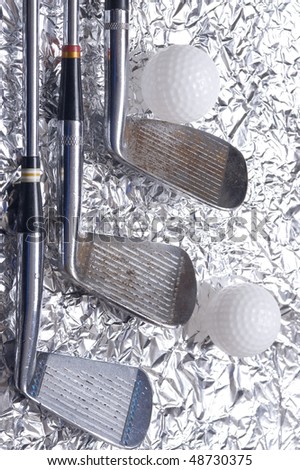 Golf club with  ball on creative metallic background