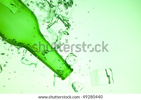 Green bottle with creative splashing green water