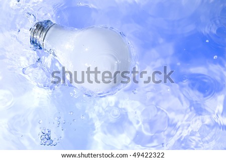 Light bulb in blue water. Technology background