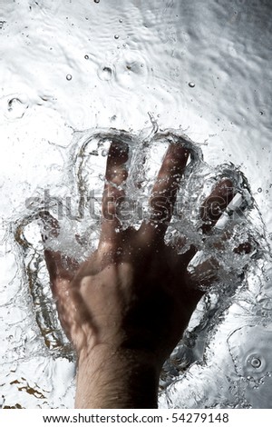 Hand on the Black water . Creative splashing dark water