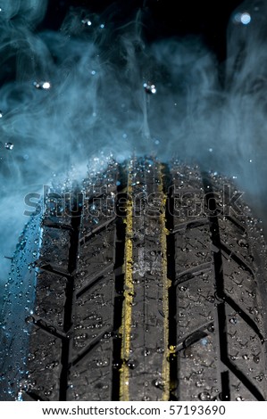Tire with water drops on it smoke background