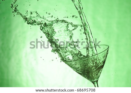 Martiniglass with stream fresh drink. Splashing cocktail