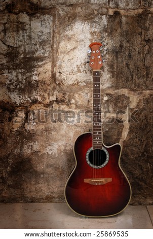 Modern acoustic guitar on wall