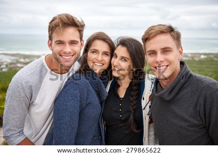 Portrait of two student couples smiling while enjoying a nature trail walk together