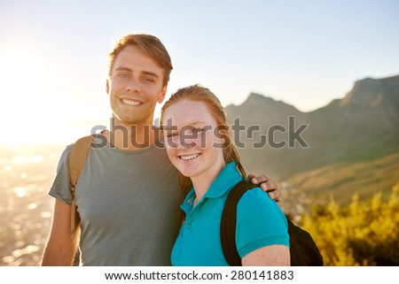 Portrait of a happy young student couple posing while on a nature hike together