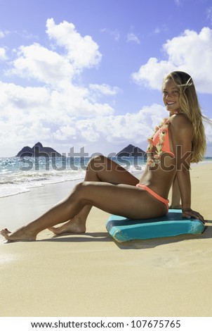 beautiful girl on the beach in bikini with boogie board