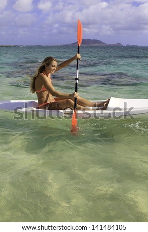 beautiful young woman with her surf ski