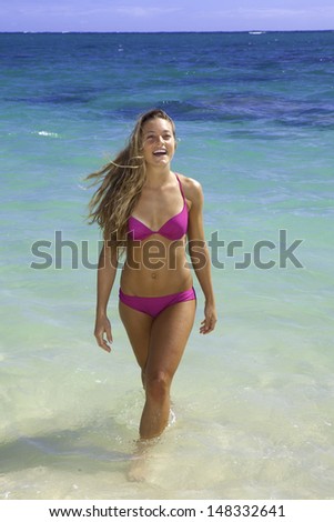 girl in pink bikini in the ocean in hawaii