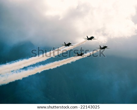 Four FA-18 jets of the U.S. Navy\'s precision flight team, the Blue Angels, fly in the skies of Hawaii.