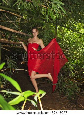 young woman in a forest of bamboo wrapped in cred chiffon