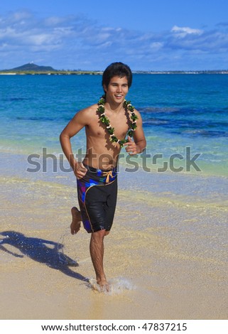 young pacific island man running on a hawaii beach