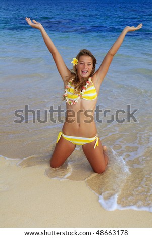 stock photo teenage girl in a bikini at a hawaii beach wearing a lei