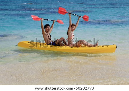 stock photo : young couple kayaking in hawaii