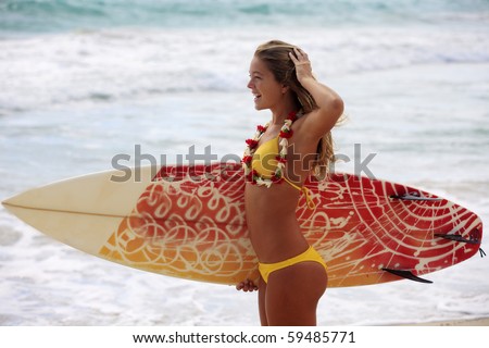 stock photo teenage girl in a yellow bikini with her surfboard at a hawaii