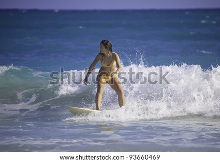 young woman surfing in hawaii