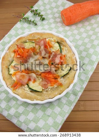 Pizza with zucchini, carrot, ham and mozzarella