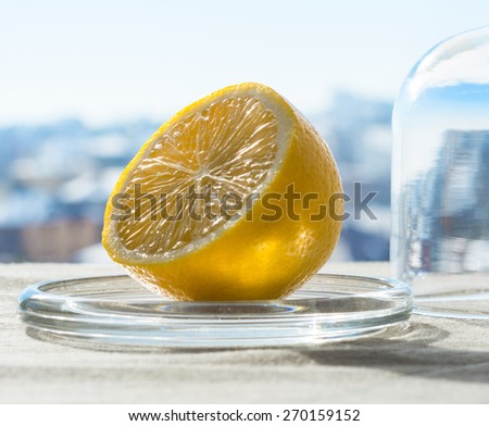 Fresh lemon in opened glass flask on the table. Winter.