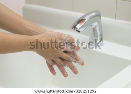 Washing of hands with soap.