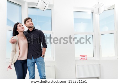 young pair, searching the real estate for a purchase