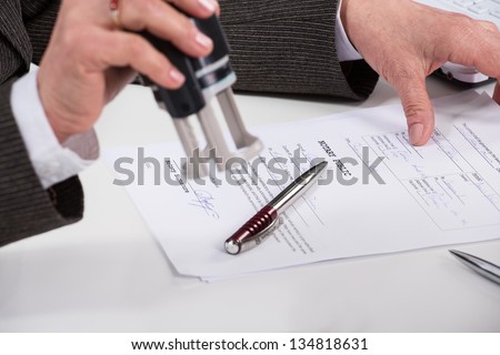 Notary public signing document at his workplace