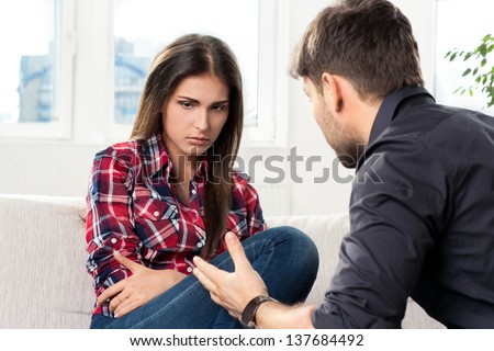 quarreled young couple in their living room