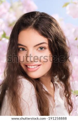 Portrait of happy smiling beautiful young woman, outdoors