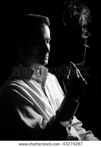 man thinks and smokes a cigarette. Monochrome