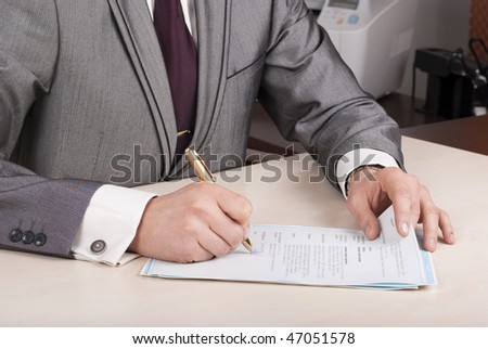 notary signing a documents, focus is on the tip of the hands